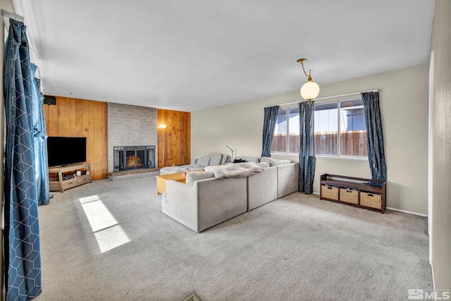 living area featuring carpet floors, a brick fireplace, and wooden walls