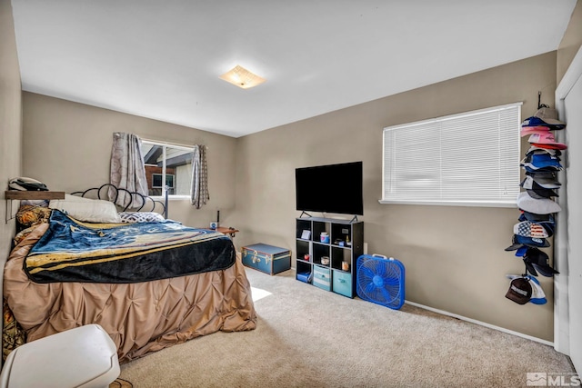 bedroom with carpet and baseboards