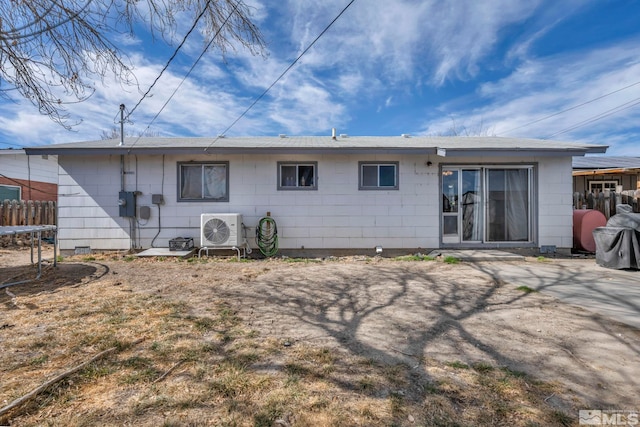 rear view of house with a trampoline, ac unit, and fence