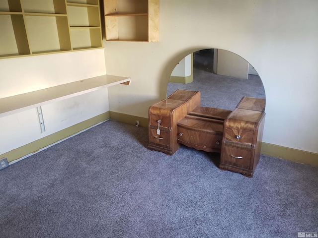 living area featuring carpet flooring and baseboards