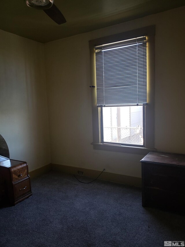 bedroom featuring baseboards, carpet floors, and a ceiling fan