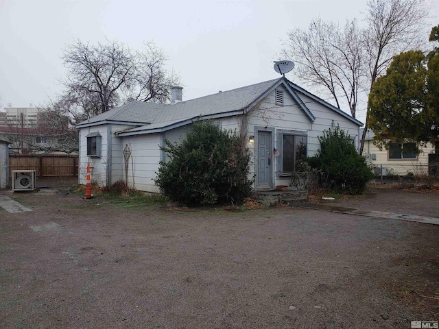 view of front of house with ac unit and fence