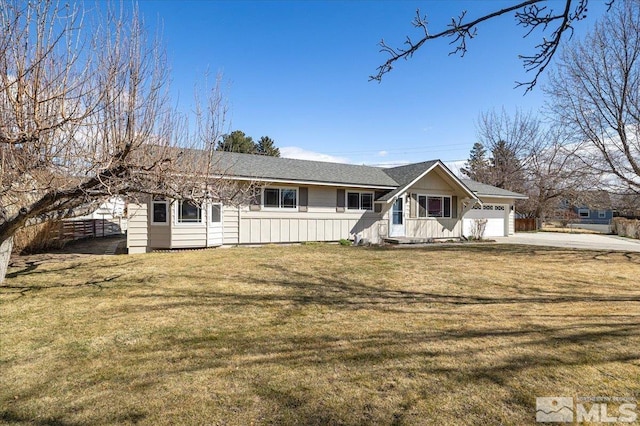 single story home featuring a garage, concrete driveway, and a front yard