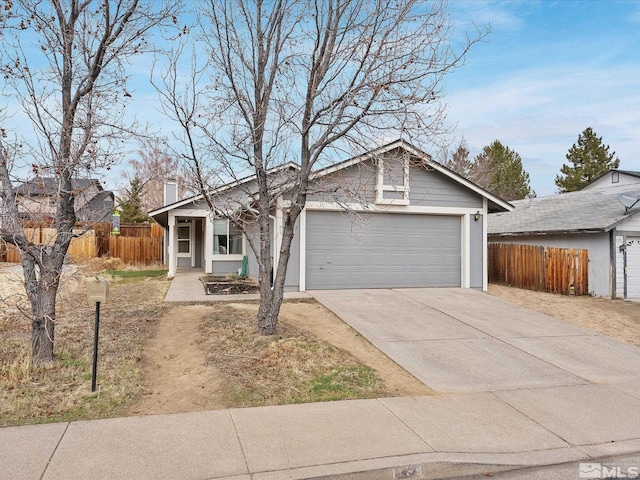 view of front facade featuring driveway, an attached garage, and fence