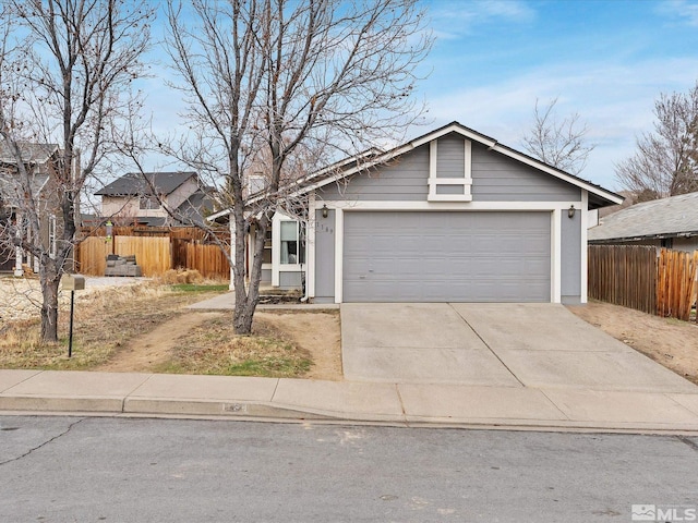 view of front facade featuring a garage, concrete driveway, and fence