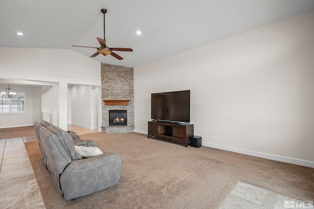 living area with ceiling fan with notable chandelier, a fireplace, and baseboards