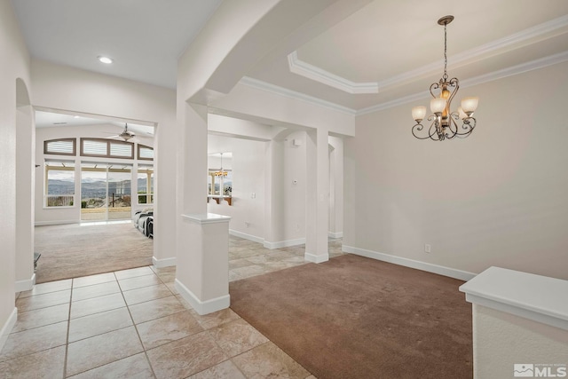 foyer with arched walkways, baseboards, light colored carpet, ornamental molding, and ceiling fan with notable chandelier