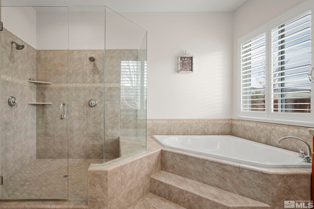 full bathroom featuring a shower stall and a bath