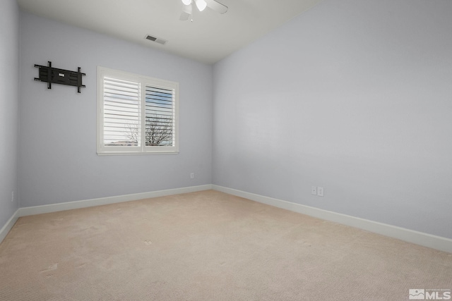 unfurnished room featuring light carpet, visible vents, baseboards, and ceiling fan