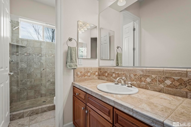 full bath featuring a stall shower, vanity, and toilet