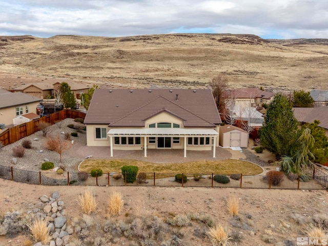 exterior space with a fenced backyard, a patio, and a mountain view