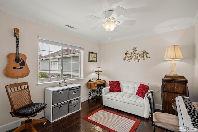 living room featuring baseboards, visible vents, a ceiling fan, dark wood finished floors, and crown molding