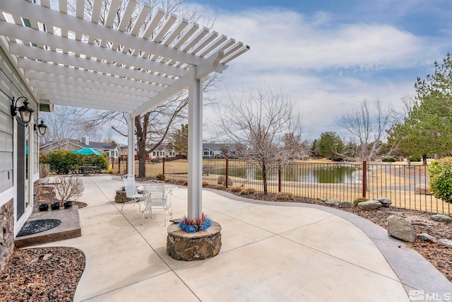 view of patio / terrace featuring a water view, a fenced backyard, and a pergola