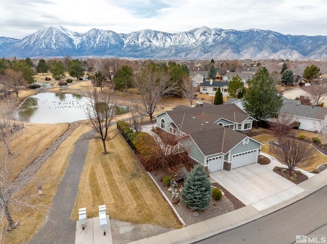 birds eye view of property featuring a water and mountain view and a residential view