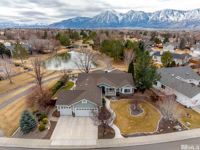 drone / aerial view featuring a residential view and a water and mountain view