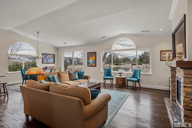 living area with vaulted ceiling, visible vents, dark wood finished floors, and a stone fireplace