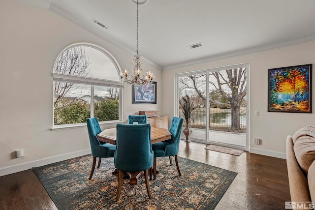 dining space featuring hardwood / wood-style floors, visible vents, and crown molding