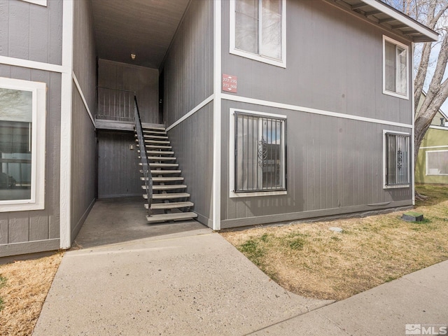 view of side of home featuring stairway