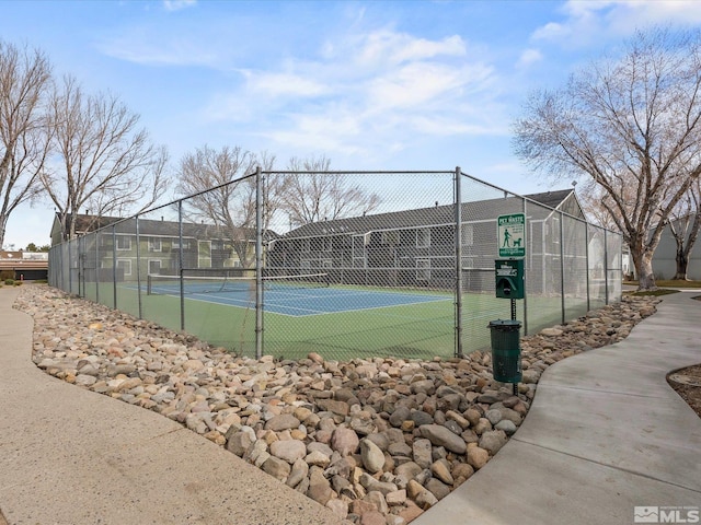 view of sport court featuring fence