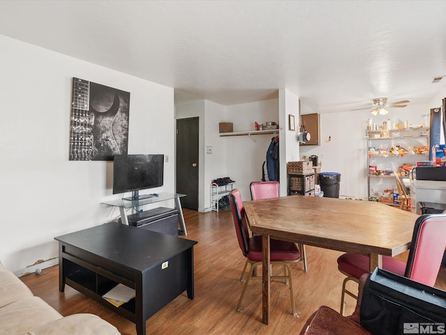 dining room featuring a ceiling fan and wood finished floors