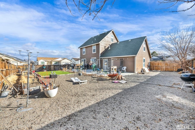 back of house with a patio area and a fenced backyard