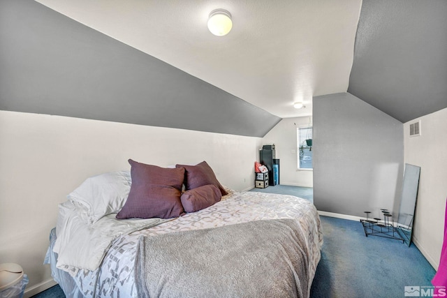 bedroom with vaulted ceiling, carpet flooring, visible vents, and baseboards