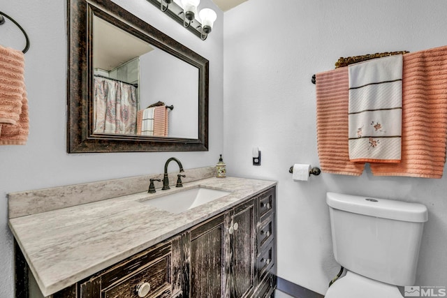 bathroom featuring toilet and vanity