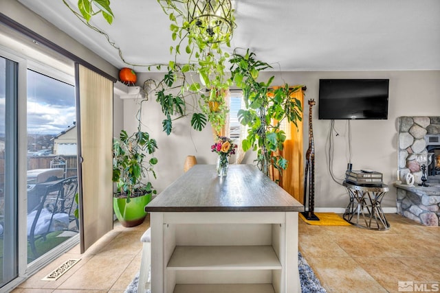 dining space featuring tile patterned flooring, visible vents, and baseboards