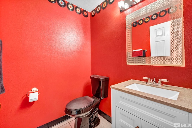 half bath with tile patterned flooring and vanity