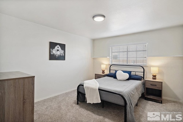 bedroom featuring light colored carpet and baseboards