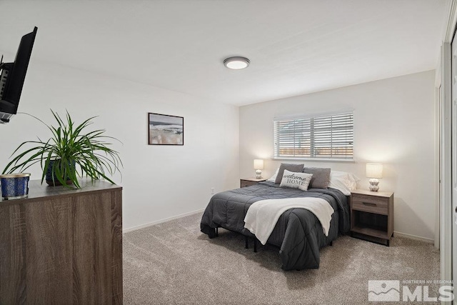 bedroom with light colored carpet and baseboards