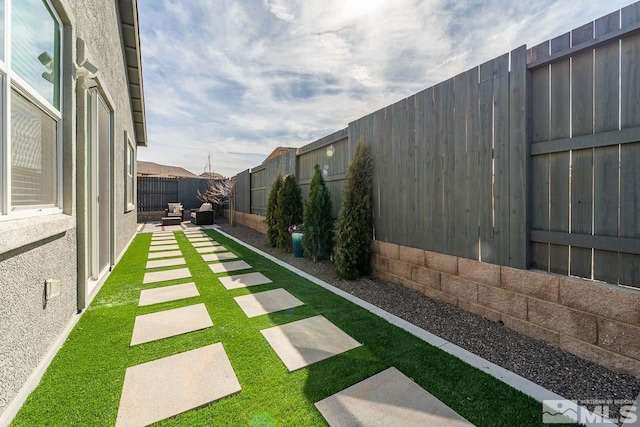 view of yard with a fenced backyard