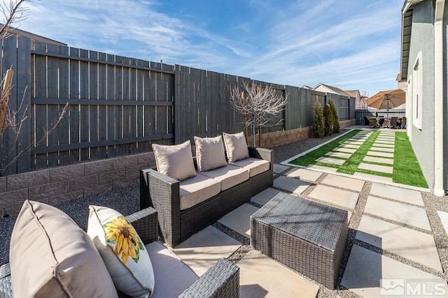 view of patio featuring a fenced backyard and an outdoor living space