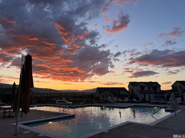 community pool with fence and a patio