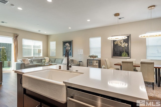 kitchen with hanging light fixtures, visible vents, open floor plan, and dishwasher