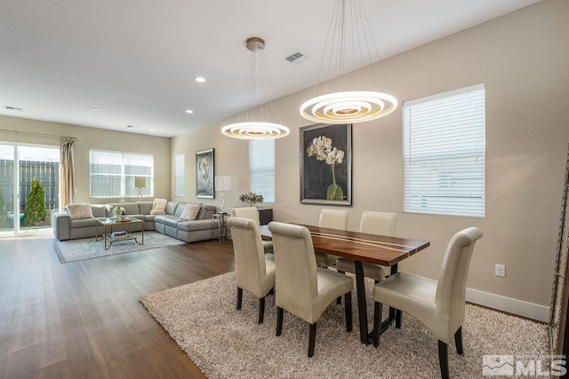 dining space with baseboards, visible vents, wood finished floors, and recessed lighting