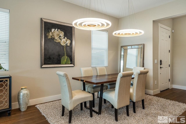 dining room with baseboards and wood finished floors