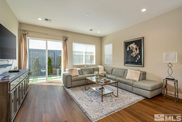 living room featuring dark wood finished floors, visible vents, and recessed lighting