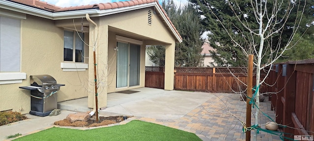 view of patio / terrace featuring grilling area and fence