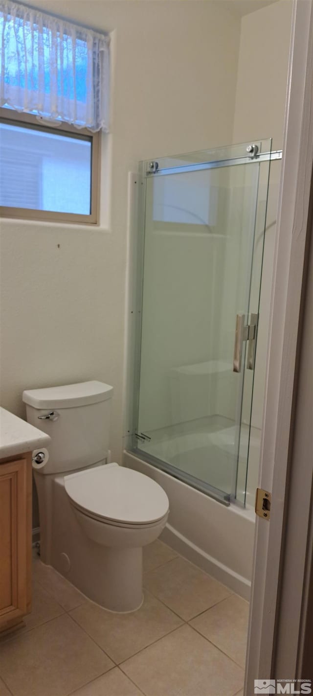 full bathroom featuring toilet, shower / bath combination with glass door, vanity, and tile patterned floors