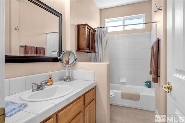 full bathroom with toilet, shower / tub combo, and vanity