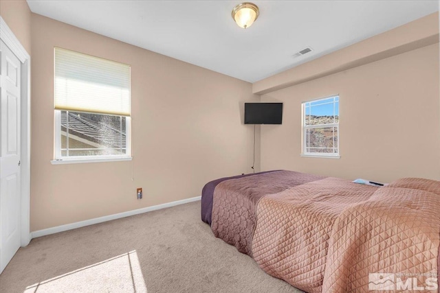 bedroom featuring carpet floors, visible vents, and baseboards