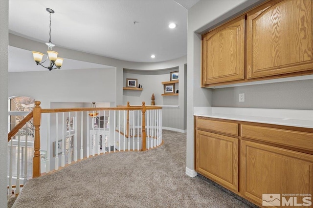 corridor with a chandelier, carpet floors, an upstairs landing, and recessed lighting