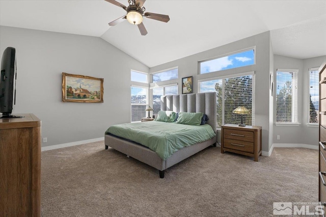 bedroom with lofted ceiling, light colored carpet, baseboards, and multiple windows