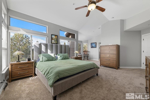 carpeted bedroom with high vaulted ceiling, ceiling fan, and baseboards