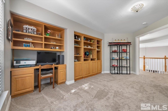 office with light carpet, a textured ceiling, and baseboards