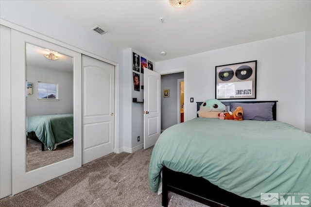 bedroom with a closet, carpet, and visible vents