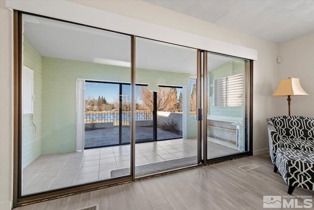 doorway to outside with wood finished floors