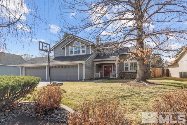 view of front of property with an attached garage, a chimney, a front yard, and fence