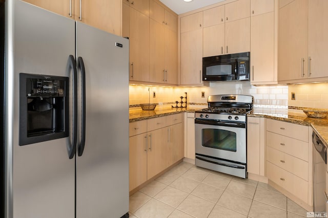 kitchen featuring stainless steel appliances, stone counters, light tile patterned flooring, and backsplash